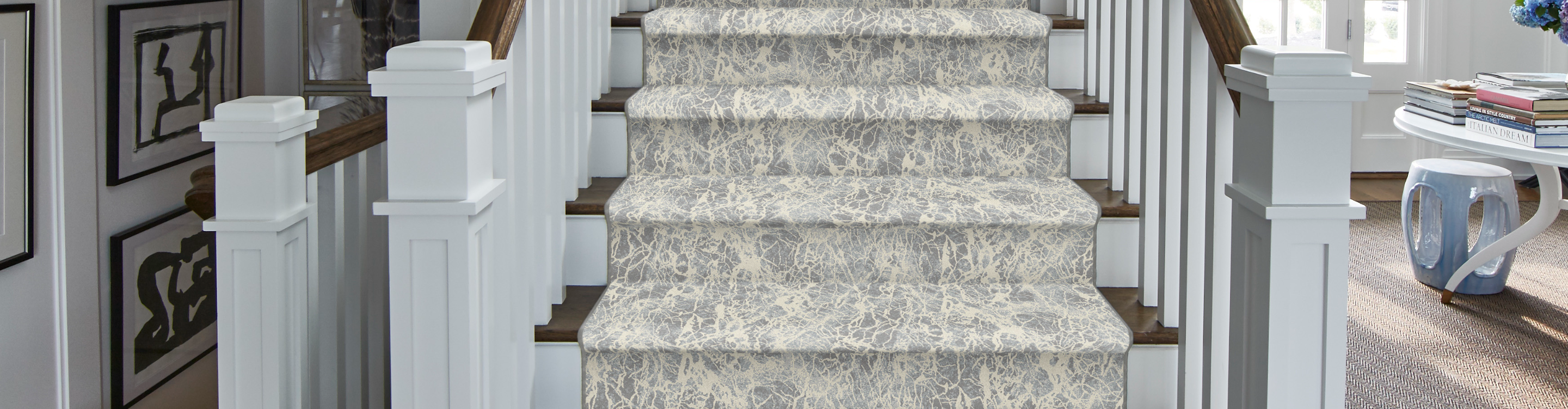 blue and white stair runner on hardwood stairs